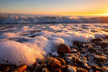 Sunrise waves on a pebbled beach