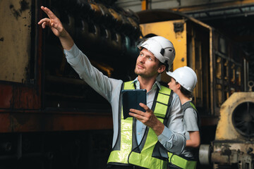 professional technician engineer with safety helmet hard hat working in industrial manufacturing...