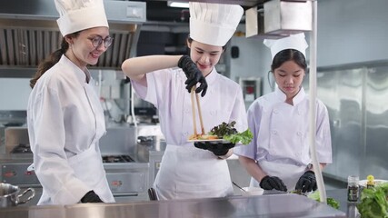 Chef instructor teaching students in kitchen class