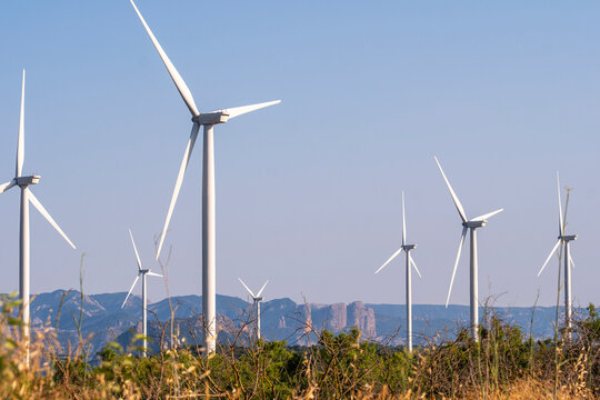 Group of wind turbines in Terra Alta, Catalonia, Spain, producing renewable electricity, symbolizing sustainable energy transition and the integration of technology with natural environment