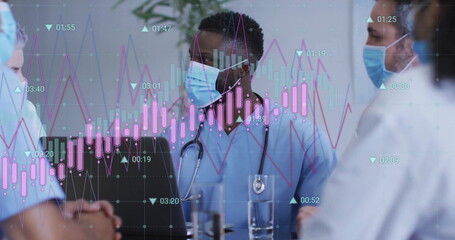 Medical team in scrubs analyzing candlestick chart in hospital room, with laptop and stethoscopes