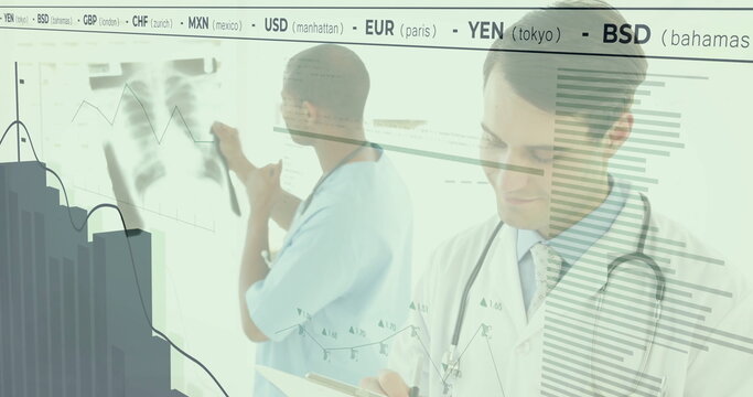 Writing male physician taking notes on clipboard in radiology suite, with financial graphs overlay