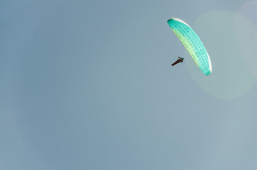Paraglider flying high above the mountains with stunning panoramic views. Adventure and extreme...