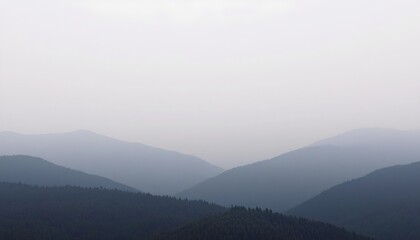 Fototapeta premium The scene portrays a landscape of mountains enveloped in a hazy atmosphere