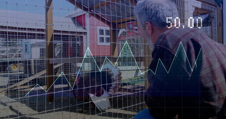 Kneeling farmer watching turkey fanning feathers beside mesh pen at farmyard, with digital overlay