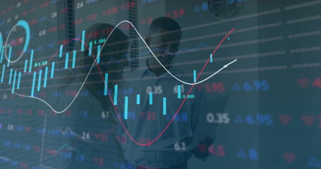 Examining analysts wearing business attire scanning tablet in office, with candlestick overlays