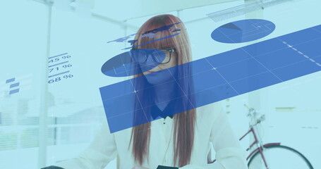 Analyzing woman in blouse examining holographic charts in modern office, with red bicycle