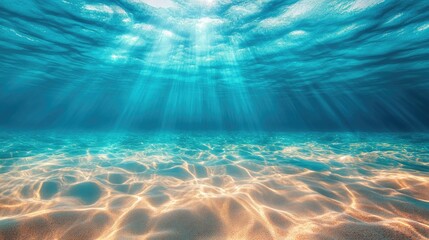 Sunlight streams through crystal-clear turquoise water, illuminating the golden sand beneath.