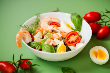 Salad with protein and greens on a green background