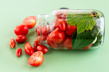Bright vegetables in a jar with dill, garlic and basil on top