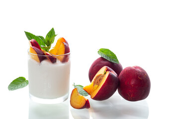 Ripe juicy nectarines in homemade yogurt isolated on white background