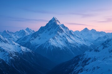 Obraz premium Snow covered mountain peaks at sunrise with pink sky
