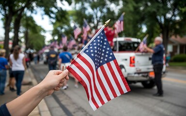 Hand holding american flag at a parade