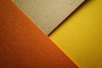 Fototapeta premium Bold Diagonal Line Dividing Warm Toned Textured Paper Composition