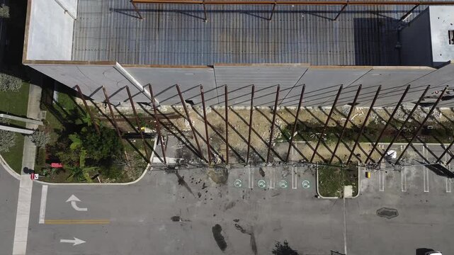 Aerial view of building construction using precast concrete wall panels with steel support columns and metal roof