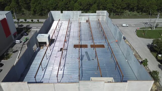 Aerial view of building construction using precast concrete wall panels building with steel support columns and metal roof