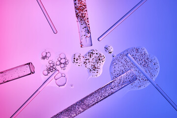 Test tubes with serums and various scientific laboratory supplies on a blue-purple background.