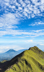 mountain landscape with blue sky and clouds during the summertime
