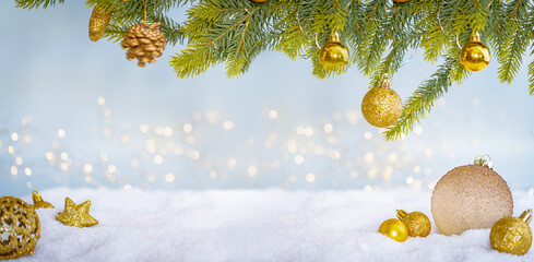 Plakat Christmas Holiday background with snow, fir tree and decorations with christmas light behind. Christmas golden balls on a winter festive background.