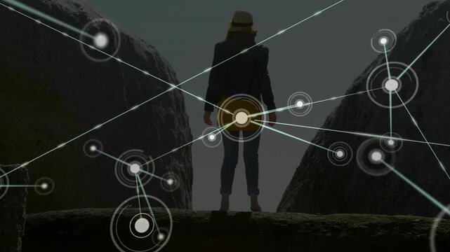 Woman standing on ledge facing horizon launching animated digital network filling canyon gap