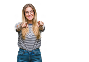 Young woman with glasses points forward with both hands smiling confidently and looking at camera transparent background