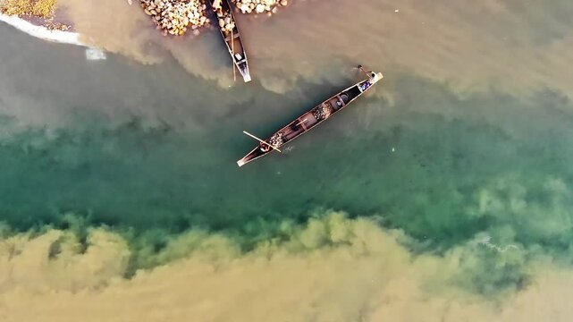 Jaflong, Bangladesh - 21 August 2025: Aerial view of boats on the river with contrasting colors and textures creating a visually striking scene.