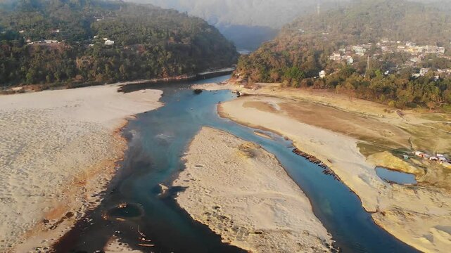 Jaflong, Bangladesh - 21 August 2025: Aerial view of the river snaking through sandy expanses, framed by lush hills and scattered settlements.