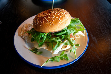 A hamburger with two fried eggs on a plate at a restaurant in Amsterdam, Netherlands.