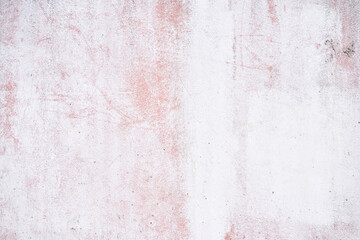 White and pink textured concrete wall with subtle scratch patterns and weathered appearance.