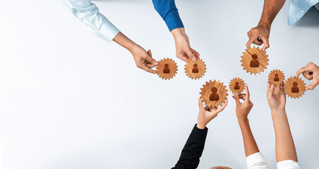 This image illustrates the concept of networking with diverse hands joining gears, symbolizing professional connections and teamwork in a modern work environment. Amity