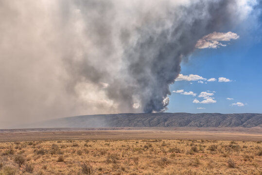 Smoke from the Dragon Bravo Wildfire at the Grand Canyon over Kaibab Plateau viewed from Vermilion Cliffs, Arizona, USA