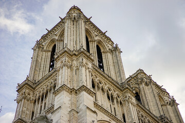 View of one of the towers of Notre Dame Cathedral in Paris France The sky is a little cloudy and...