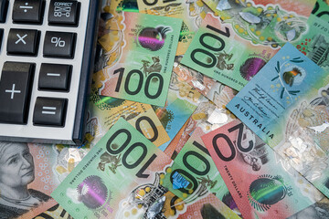 Colorful Australian banknotes with calculator used for budget calculation and expense tracking