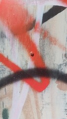 Spray paint graffiti details close-up on an old metal surface, abstract background