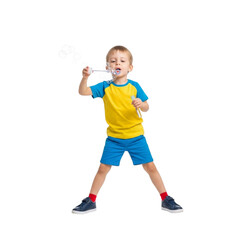 A young boy in a yellow and blue outfit blowing bubbles with a bubble wand against  scene on transparent background