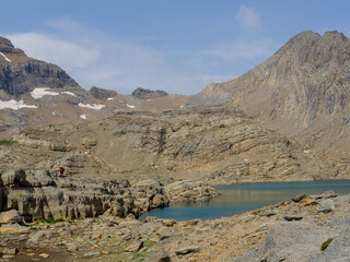 Hiker by Marbore Lake in Monte Perdido Massif, Spanish Pyrenees