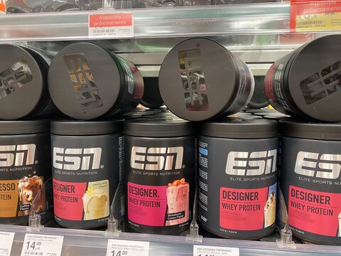 Santa Ponsa, Spain - August 20, 2025: ESN Elite Sports Nutrition protein powder containers displayed on supermarket shelf, showcasing various flavors and packaging designs for fitness enthusiasts