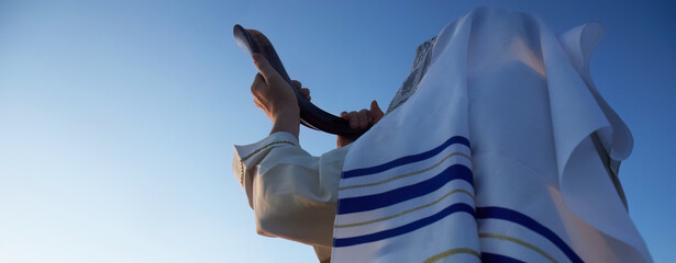Jewish man blowing the Shofar horn of Rosh Hashanah - New Year.