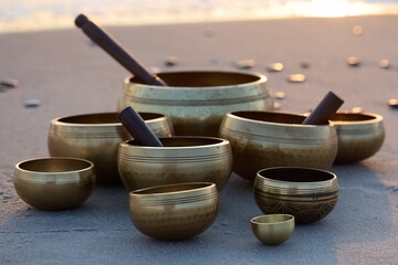 Singing Bowls on Beach at sunrise.