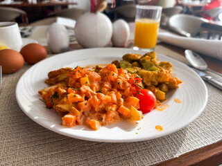 Plate of cooked vegetables with tomato sauce and juice on table. Healthy breakfast, Mediterranean cuisine and lifestyle tradition in dining culture.