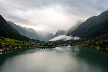 Norway villages in fjord on near olden. Cloudy Nordic day.
