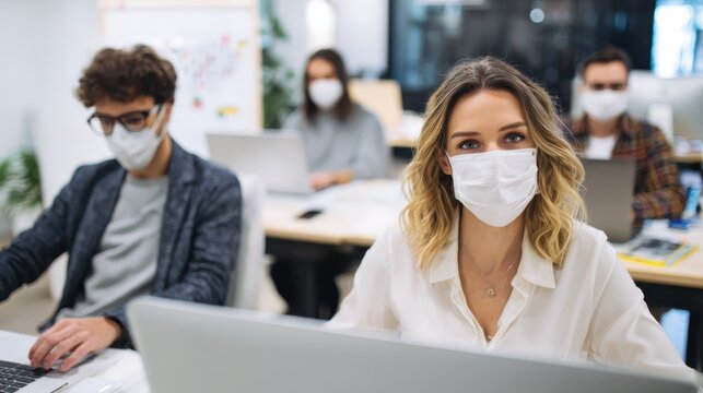 young people with face masks back at work or school in office after lockdown no logos no brands ar 169