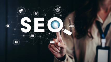 Businesswoman pointing virtual SEO icon to analyze search engine optimization for marketing and...