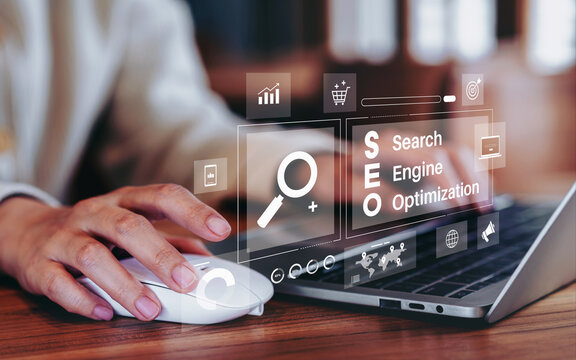 Businesswoman using a laptop for analysis SEO icon to analyze search engine optimization for marketing and online traffic on website performance improvement rankings with strategic digital techniques