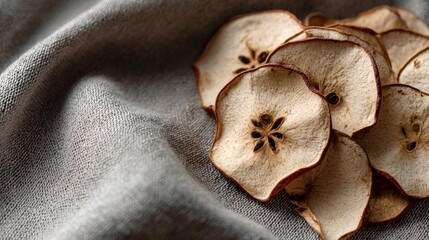 Flat lay with dried apple slices on textured neutral fabric