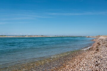 beautiful deserted beach at Selsey West Sussex England with blue sky in the background