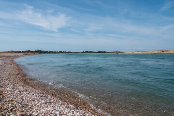 beautiful deserted beach at Selsey West Sussex England with blue sky in the background