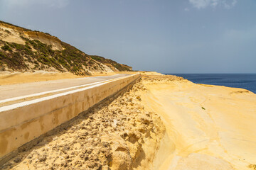 Coastal road and limestone cliffs on Gozo, Malta.