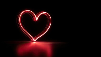 Red light heart shape on black background