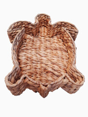 Original turtle-shaped wicker basket isolated. Aerial view of a raffia basket. Handmade household items. Crafts and basketry. Natural wicker tray.